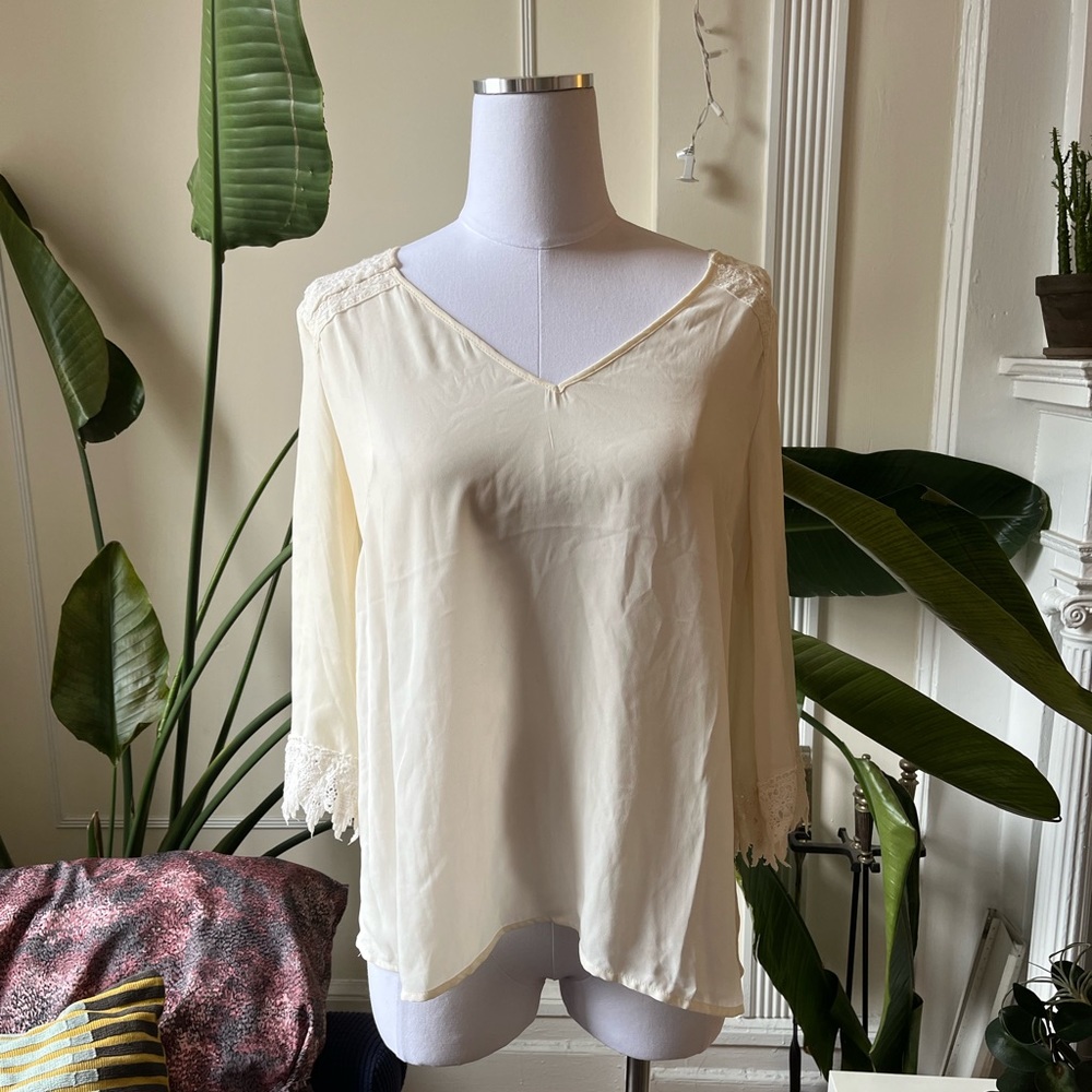 cream-colored alya blouse with lace sleeves and back decoration